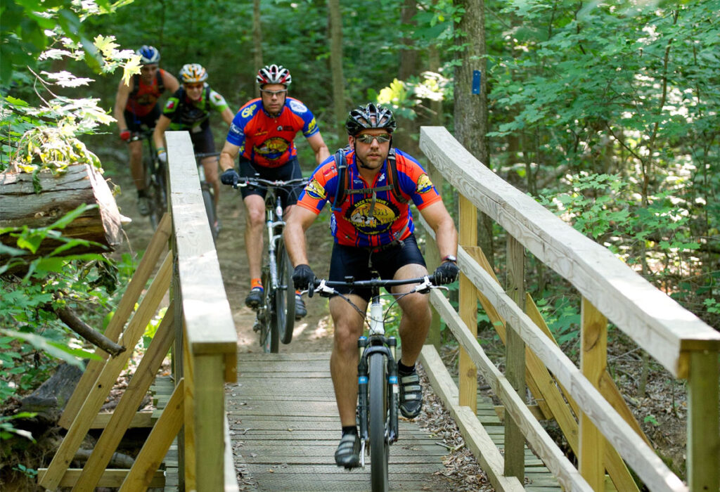 Mountain bikers crossing bridge