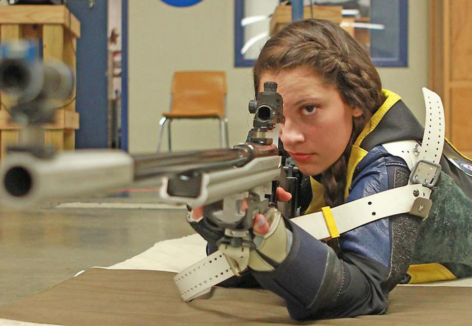 Female shooter steadies rifle